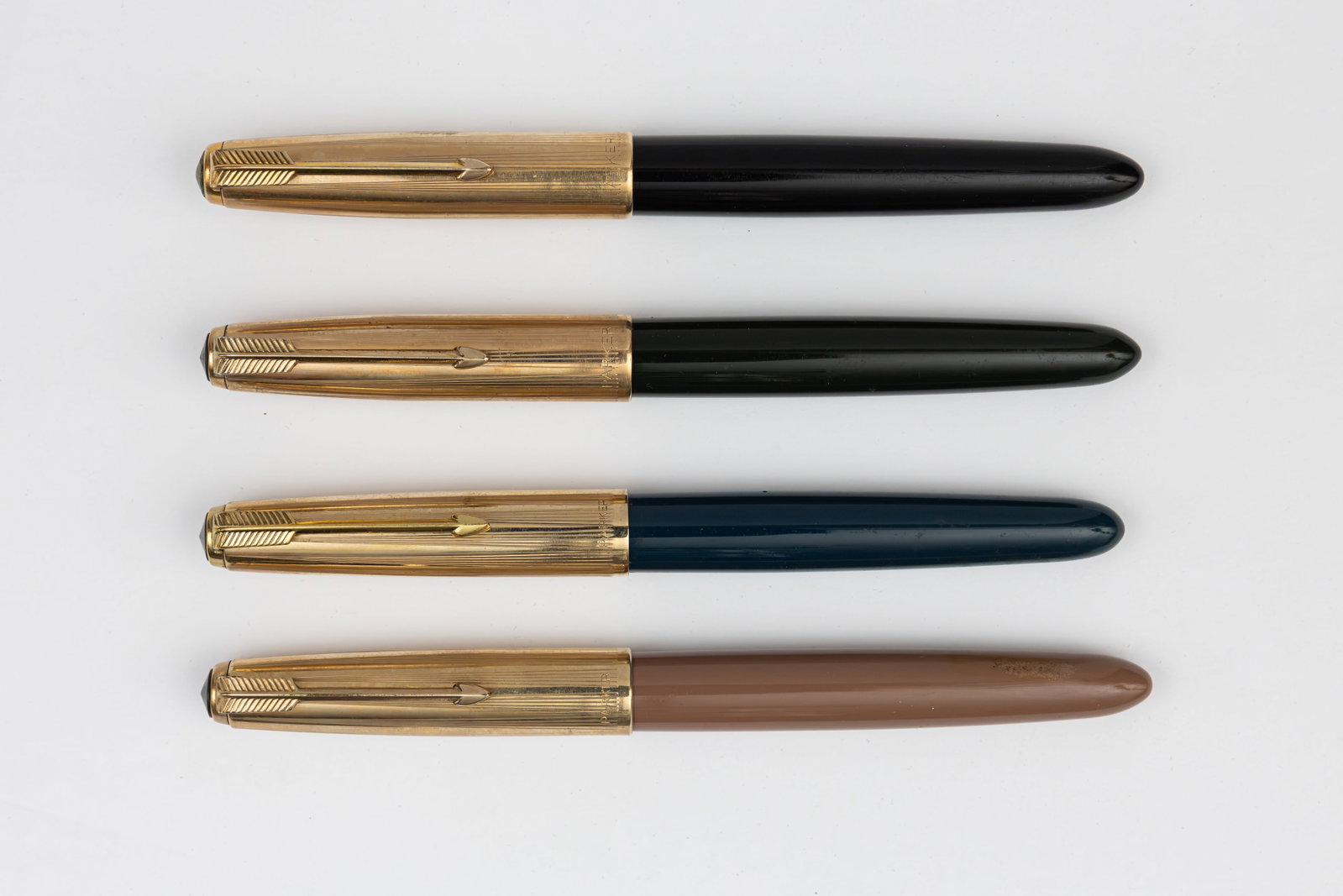 Parker 51 Demi Aerometric Fountain Pen Collection (4): Parker 51 Aerometric Demi fountain pens (4), circa 1950’s. Parker Aerometric Demi size 51 pens in black, Cocoa, Forest Green and Midnight Blue with gold filled caps and fine 14K nibs. Length 5&rdquo