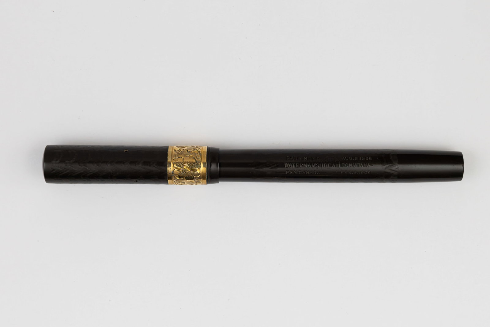 Waterman 52 Black Chased Hard Rubber Pansy Gold Band Fountain Pen: Waterman 52 black chased hard rubber pansy pattern gold band fountain pen, circa 1920’s. Clipless Waterman 52 with gold filled trim and wide pansy pattern cap band, Waterman Ideal 14K fine flexible 