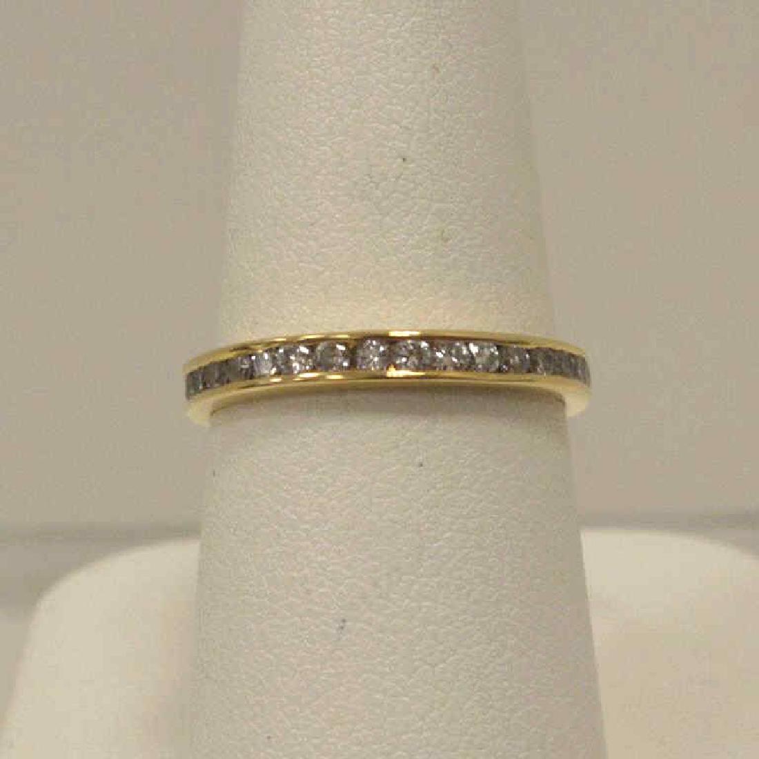14kt yellow gold diamond wedding band: Ladies 14kt yellow gold diamond wedding band featuring channel set round brilliant cut diamonds weighing approx. 0.25ct, Finger size 6.5. Weight 2.1 grams