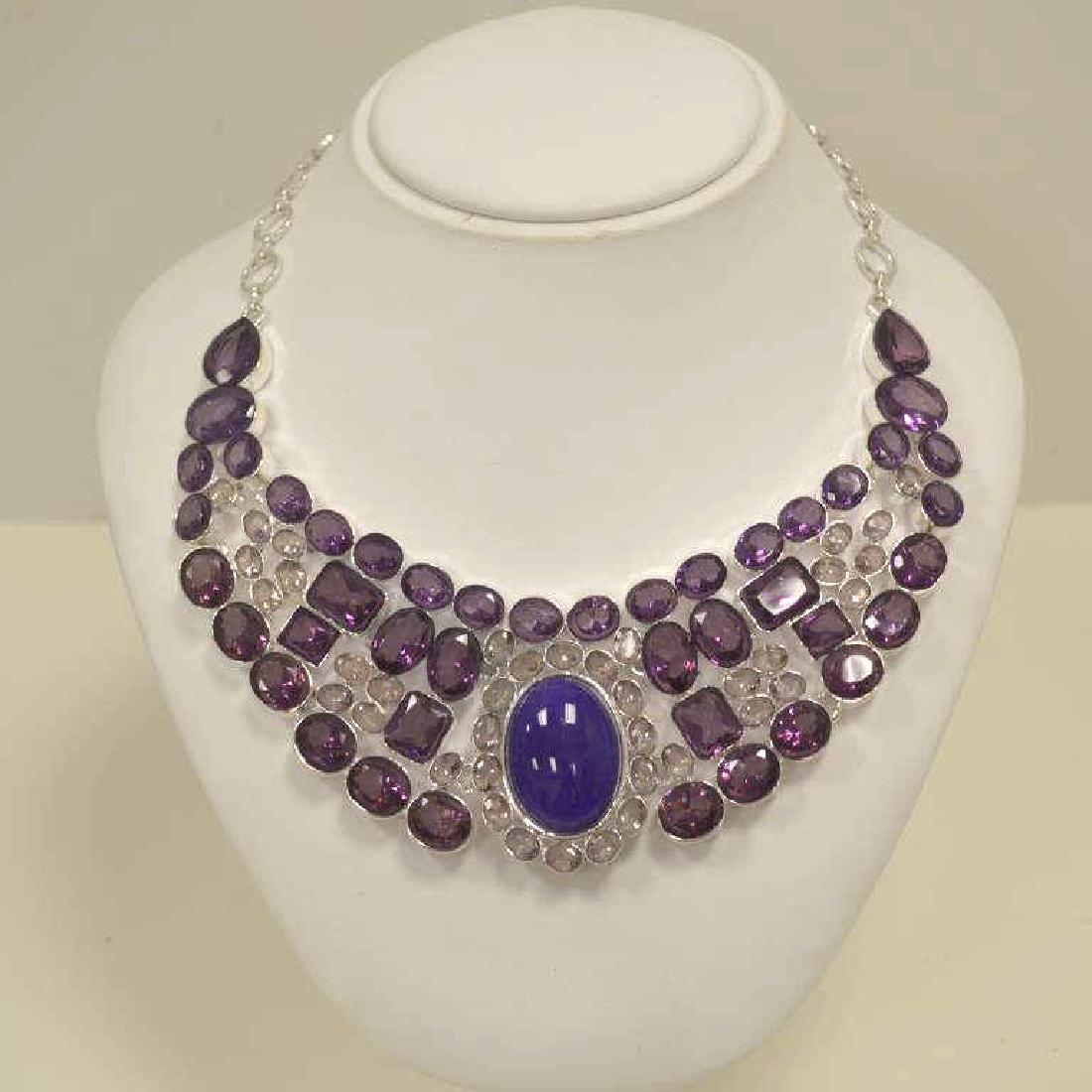 Silver plate alexandrite bib necklace: Ladies alexandrite bib necklace featuring various shapes of lab created alexandrite weighing approx. 667.00ct., bezel set in a silver plated mounting. Measures approx. 20". Weight 133.4 grams TH-262