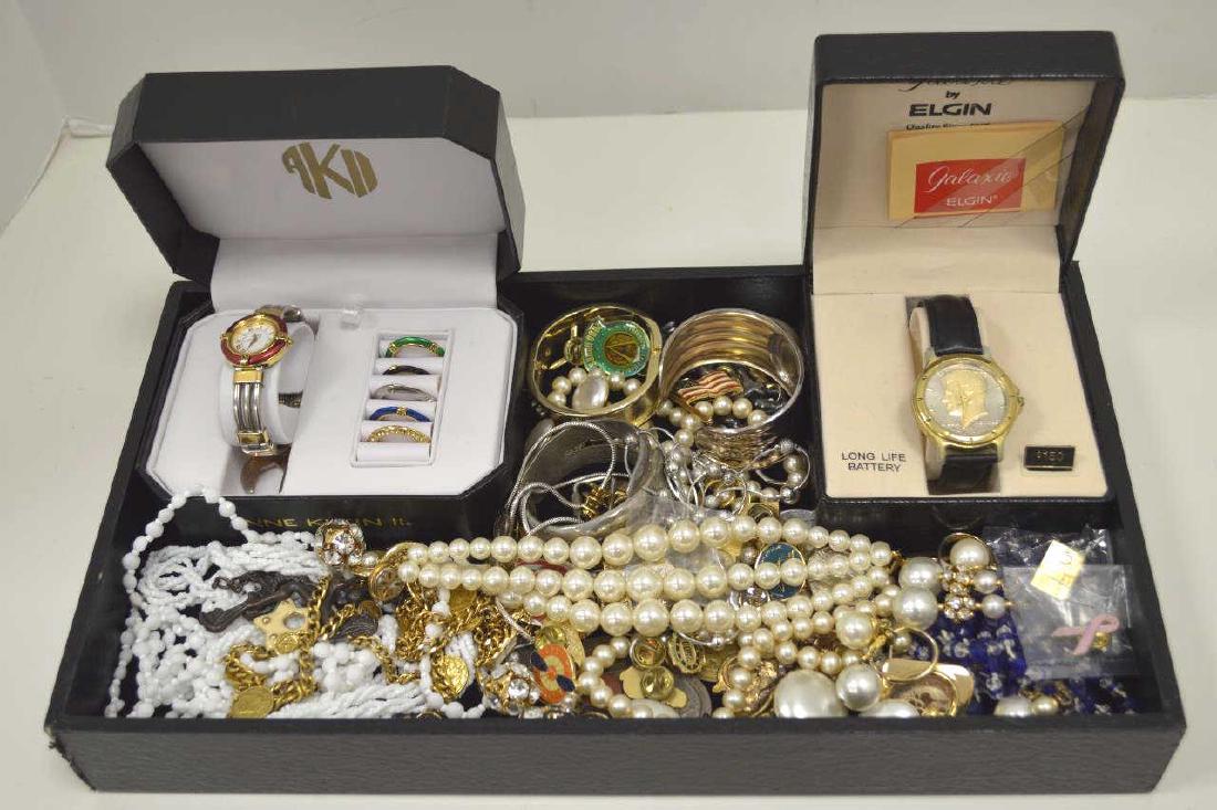 Large lot of costume jewelry: Large lot of costume jewelry including Ann Klein watch, Elgin coin watch, beaded necklaces, key chains, cuff bracelets, commemorative pins, and more.