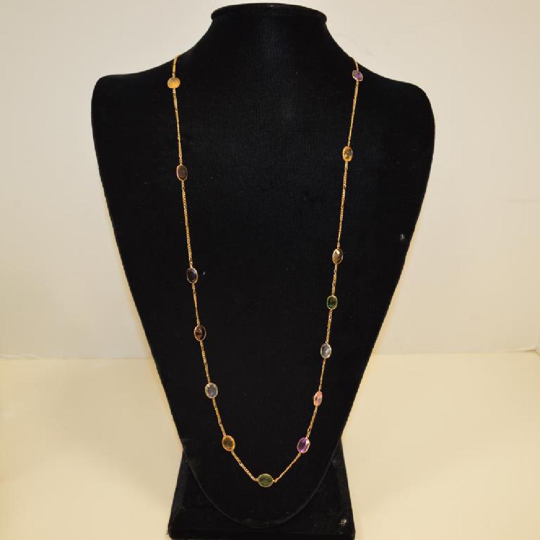 14kt yellow gold "gemstones by the yard" necklace: 14kt yellow gold "gemstones by the yard" necklace bezel set oval cut stones in various colors. Length approx. 32". Weight 14.5 grams.
