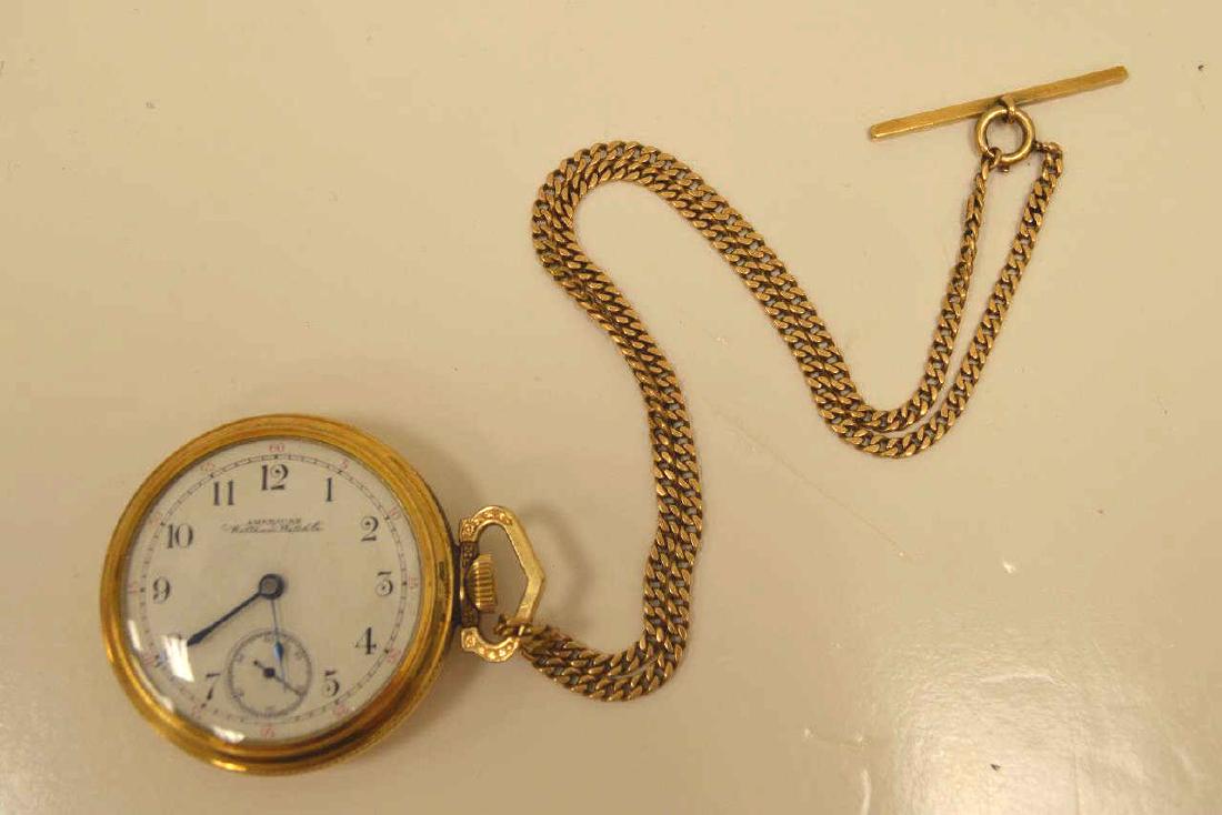 Waltham pocket watch with 14kt gold fob: American Waltham Watch Co. gold filled pocket watch featuring a white dial and 17 jewel movement. Case measures 54mm in diameter. Comes with 14kt yellow gold watch fob weighs 24.8 grams
