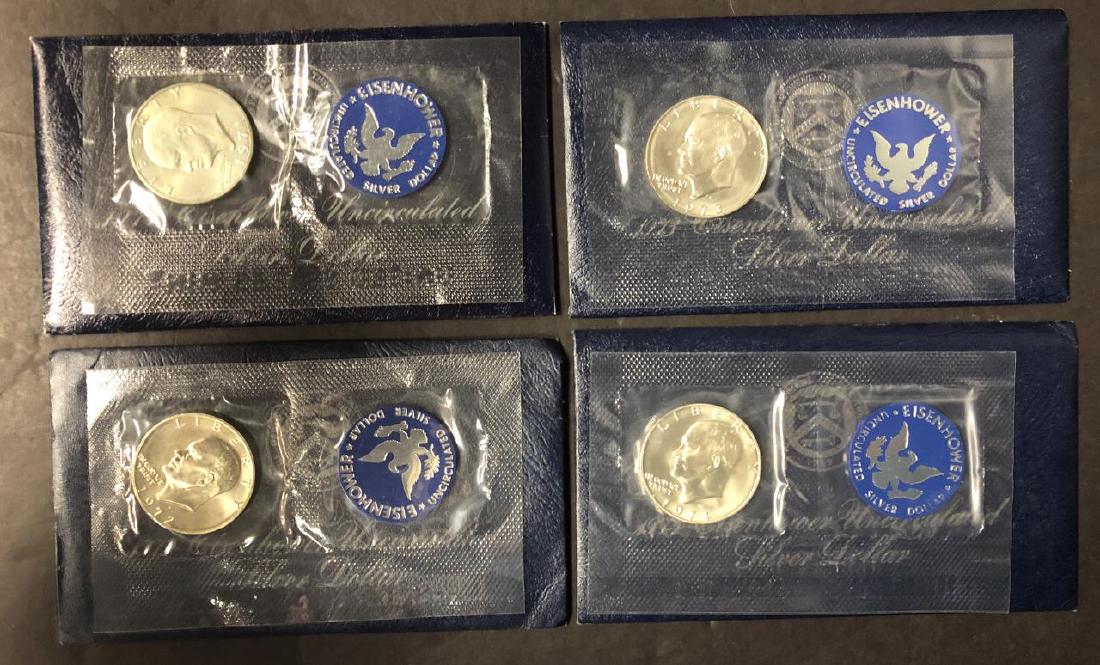 Complete Set 1971-1974 Silver UNC Eisenhower $1: Complete Set 1971-1974 Silver UNC Eisenhower $1. You get the 1971, 1972, 1973, and 1974 all in their original blue envelopes of issue, which denotes they are of the silver composition.
