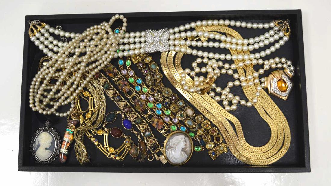 Lot of costume jewelry: Lot of costume jewelry including bright color stone and fancy link bracelets, large costume pearl necklaces, gold plated fancy link necklaces and cameos.