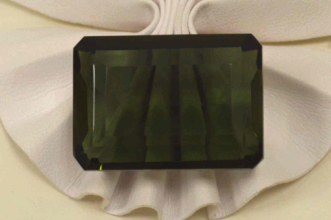 Loose 128.75ct Green Quartz: Loose 128.75ct emerald cut dark green (amethyst) quartz. Measures approx. 33.47 x 23.85 x 16.41,,. Comes with Earth Mined certificate. TH- 156