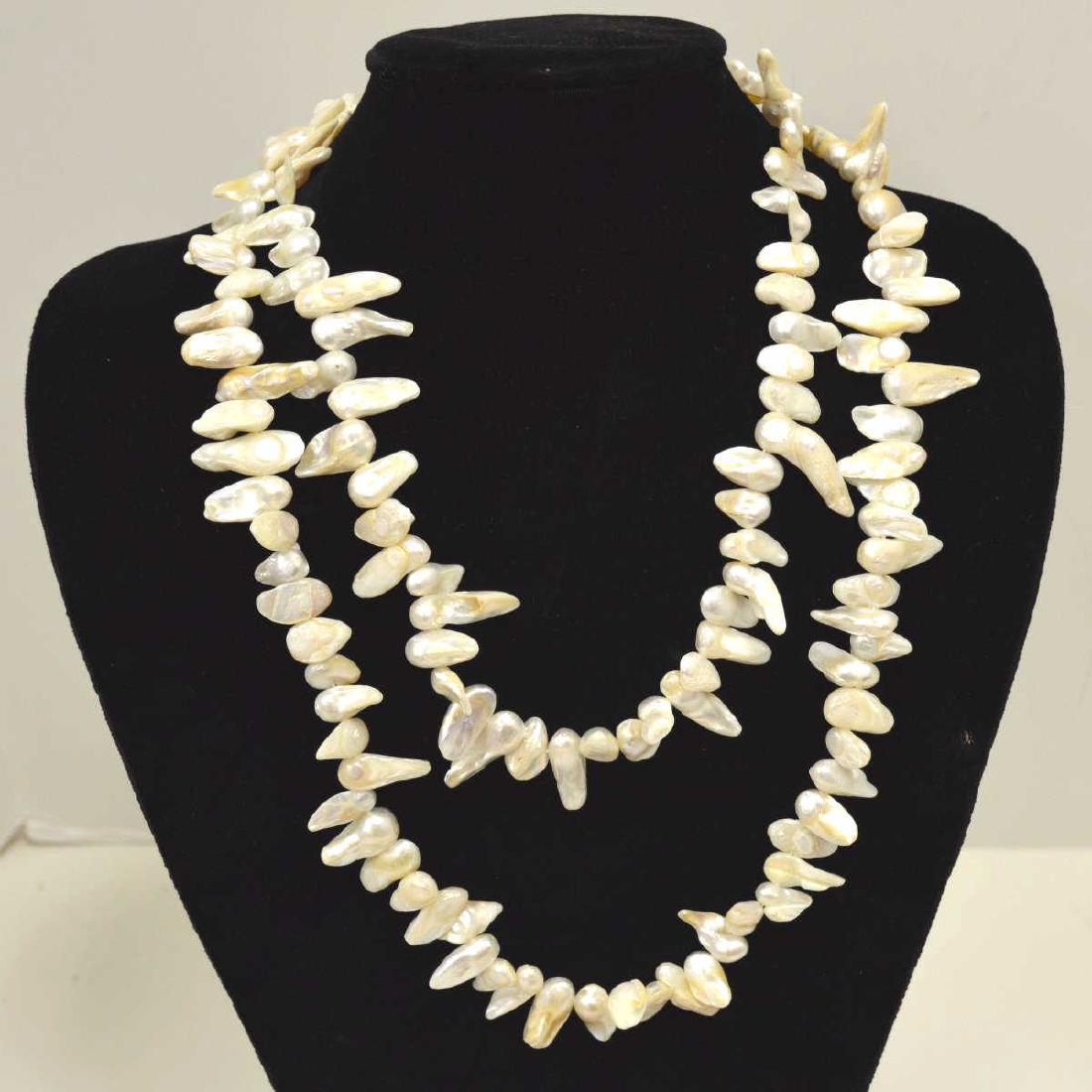 48" Freshwater Pearl Necklace: Ladies 48" continuous fresh water pearl necklace featuring 8-10mm baroque pearls in a creamy white color. Single knotted.