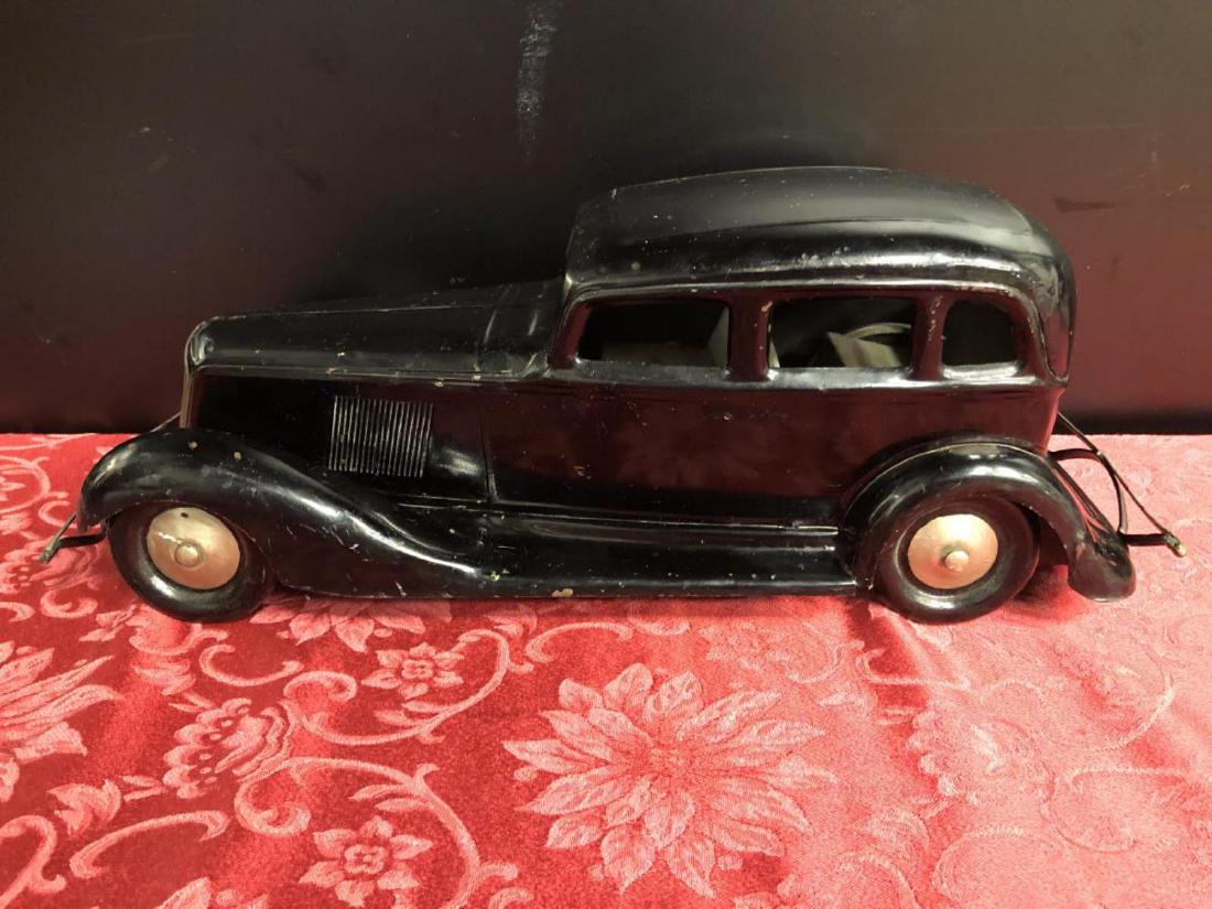 Cor-Cor 1930's Graham Paige Tin Metal Toy Car: Cor-Cor Co. Graham Paige Pressed Metal Toy Car. Model of the 1930's suicide door sedan. It is 19.5" long, 7" tall. It has age appropriate wear or use. It has three head figures on all the hub caps & t