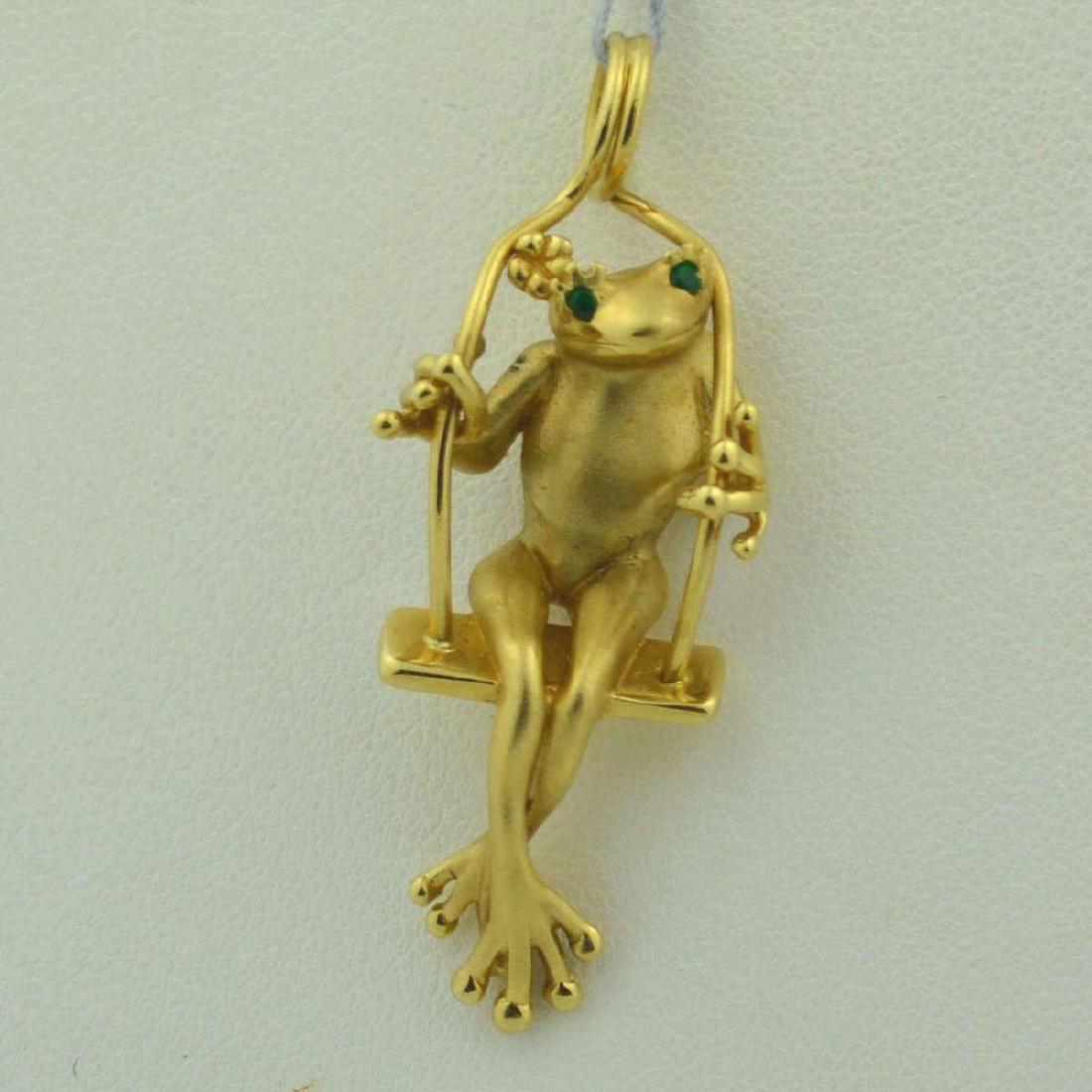 14kt yellow gold Frog Pendant: 14kt yellow gold swinging frog pendant accented with green emerald eyes. Lenght 1 1/2",Weight 7.7gr.