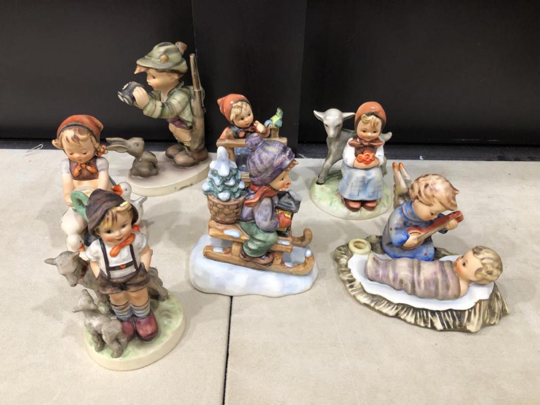 Lot of 7 Goebel Hummel Figurines: Lot of Seven W. Goebel figurines designed by M.I. Hummel. Nativity candle holder with angle & baby 24/I 3.5" x 5.5" long, Boy with sled & lantern 396 2/0 1981 4.75" tall, Signs of Spring girl with fen