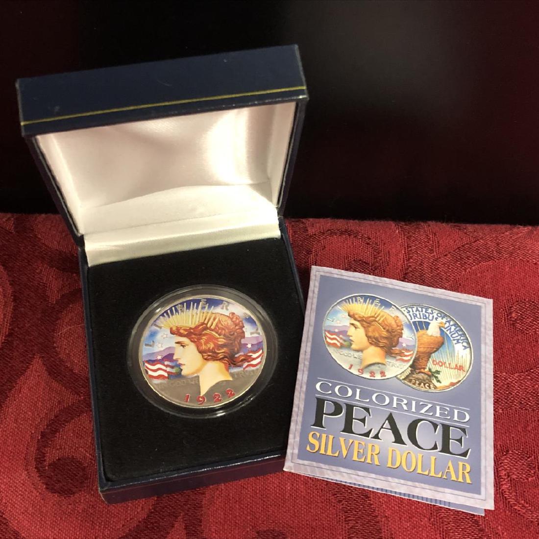 1922 Colorized Peace Silver Dollar in Case: 1922 Colorized Peace Silver Dollar in Presentation Case. Housed in a plastic capsule, this original 1922 Peace "Victory" silver dollar coin is colorized on both sides.