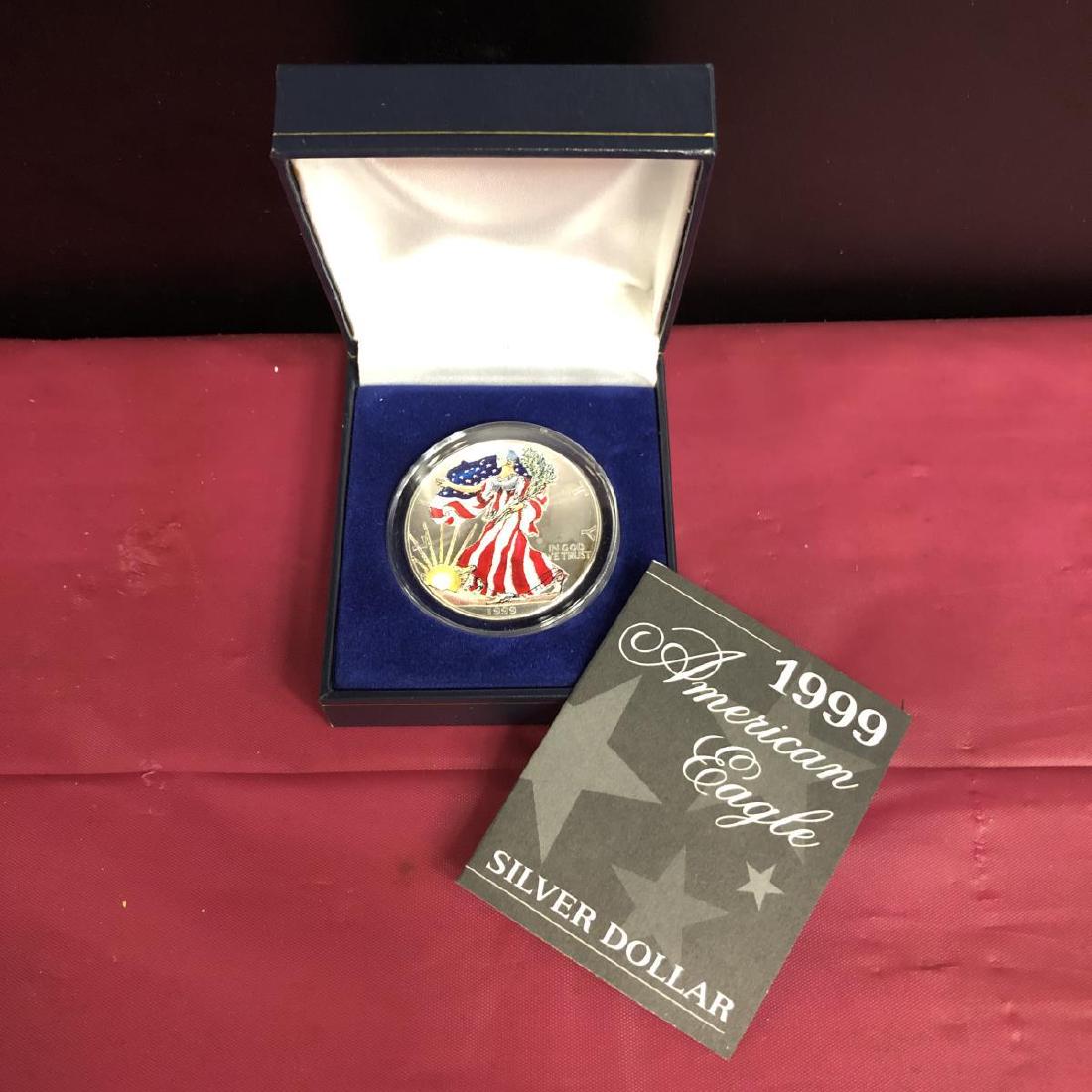 1999 Colorized American Silver Eagle in Case: 1999 Colorized American Silver Eagle in Presentation Case. Housed in a plastic capsule and presentation box with COA, this 1-ounce silver American Eagle coin has Lady Liberty and the Rising Sun colori