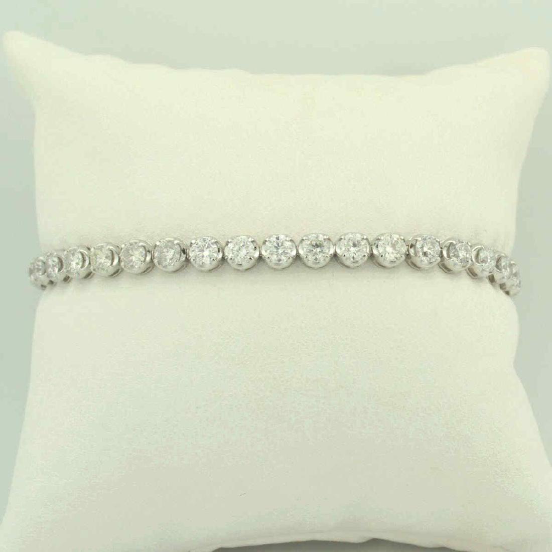 18kt white gold diamond tennis bracelet: Ladies 18kt white gold diamond tennis bracelet featuring prong set round brilliant cut diamonds weighing approx. 7.05ct., Clarity SI3- I2, Color F-H. Length 7 1/4". Weight 11.8 grams. Comes with an AI