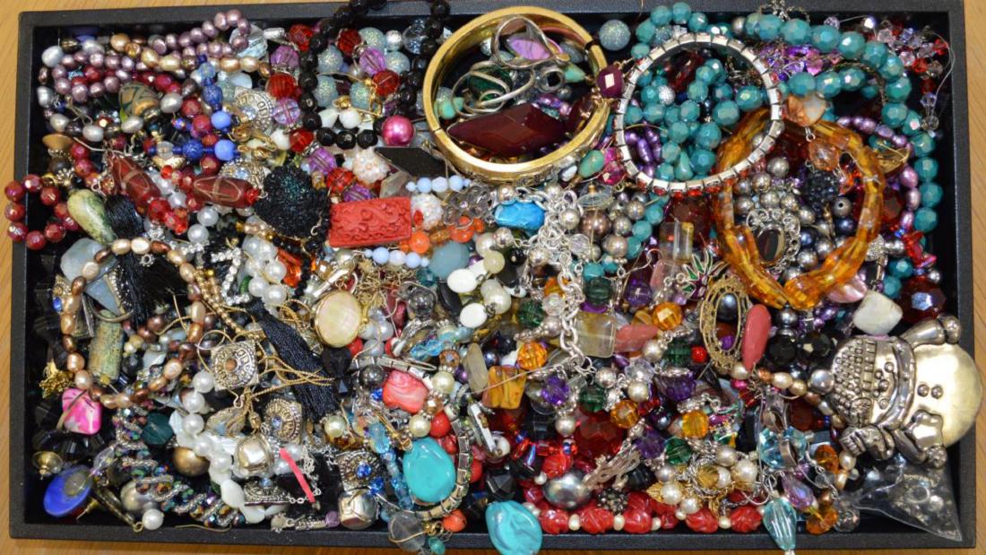 Large lot of costume jewelry: Large lot of costume jewelry including including beaded necklaces, dangle earrings, large snowman brooch, elastic beaded bracelets, bangle bracelets and more.