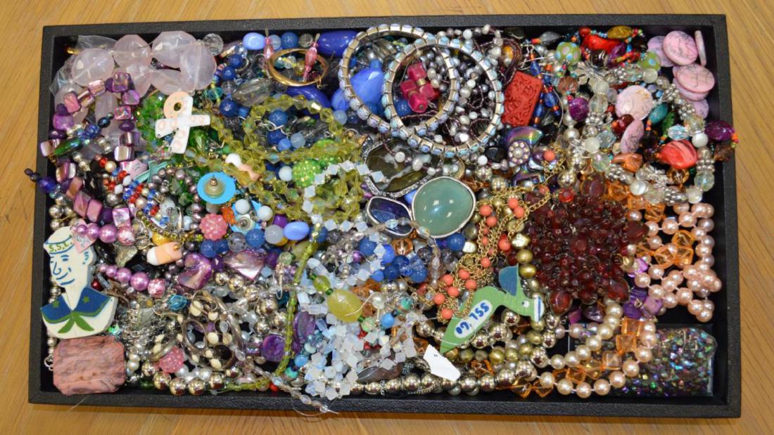 Large lot of costume jewelry: Large lot of costume jewelry including including beaded necklaces, dangle earrings, elastic beaded bracelets, wooden pins, large flower brooch and more.