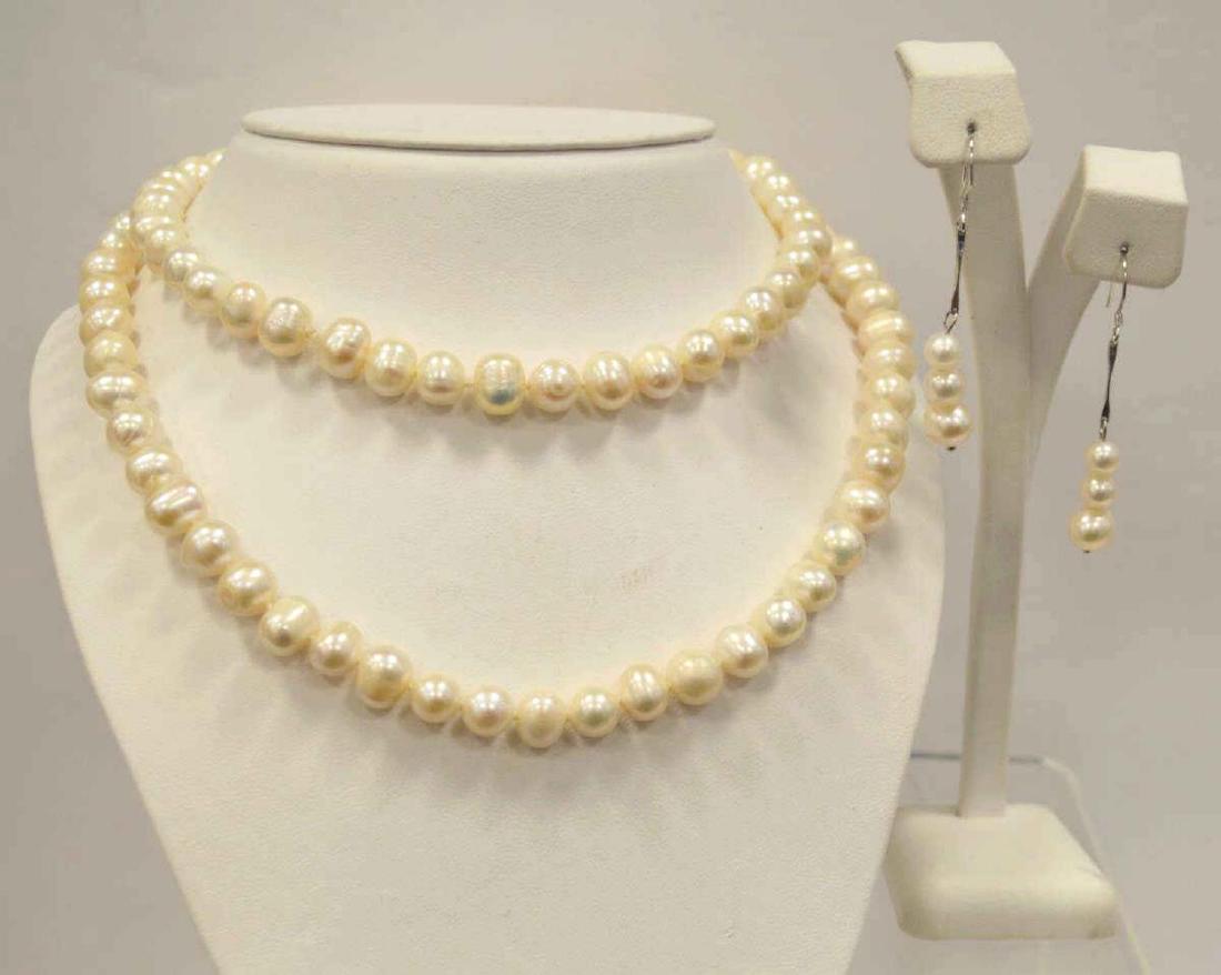 32" Freshwater Pearl Necklace and Earrings: Ladies 32" fresh water pearl necklace featuring single knotted 8-10 mm baroque creamy white color pearls. Also includes matching drop earrings.