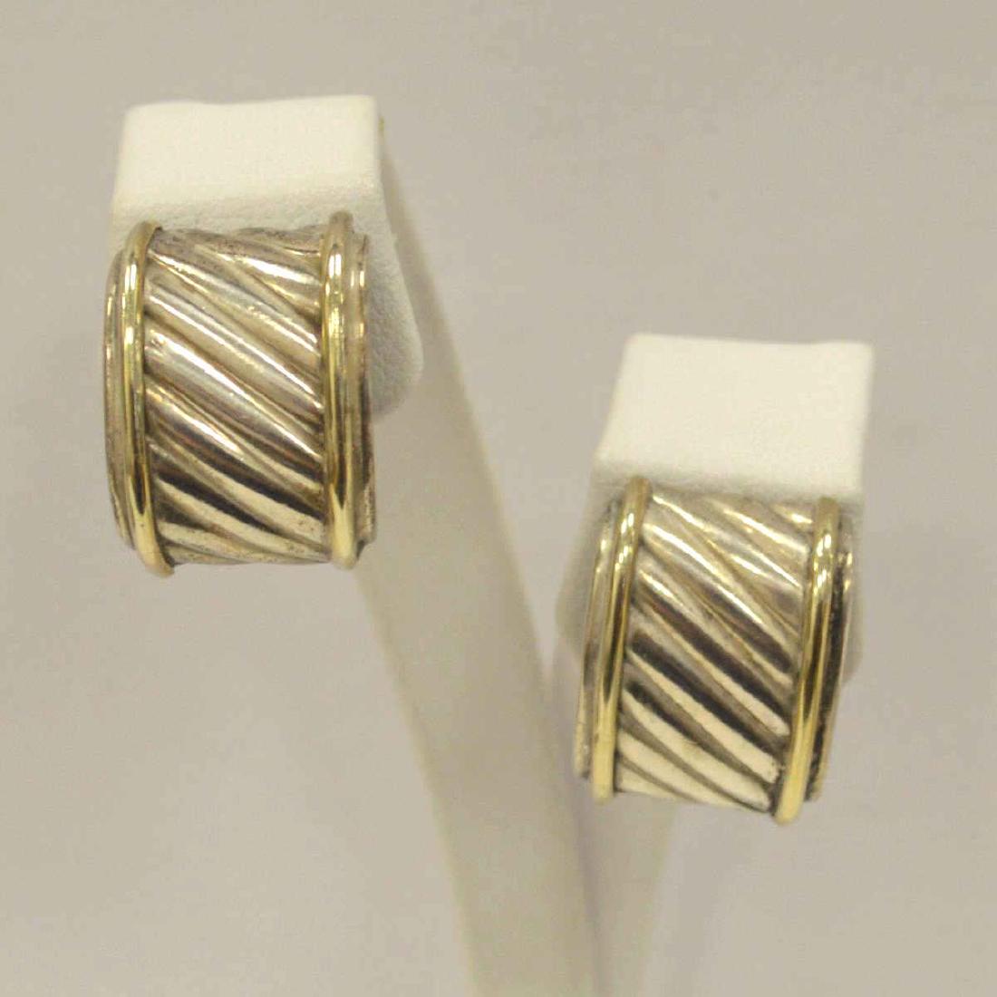 David Yurman Thoroughbred Earrings: Ladies David Yurman 14kt yellow gold and sterling silver Thoroughbred clip on earrings featuring a textured cable design and finished with omega backs. Length 19mm. Weight 0.45 ozt.