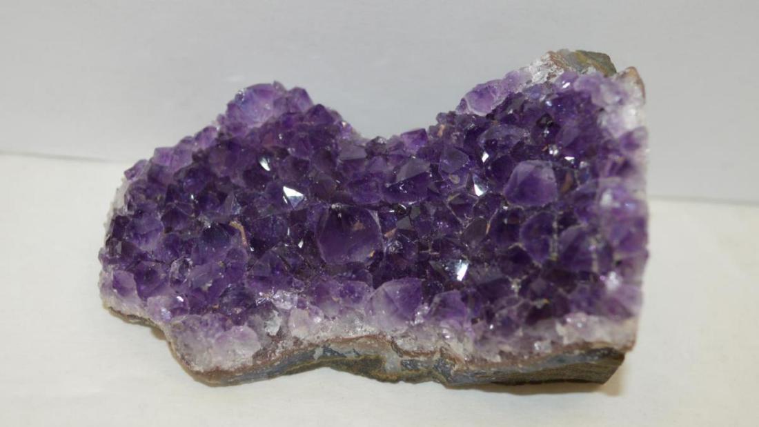 Piece of Amethyst Geode: Piece of Amethyst Geode weighing approx. 771.00ct. Displaying rich purple color and cut so the piece can be free standing. Measures approx. 3 1/4" tall. TH-384