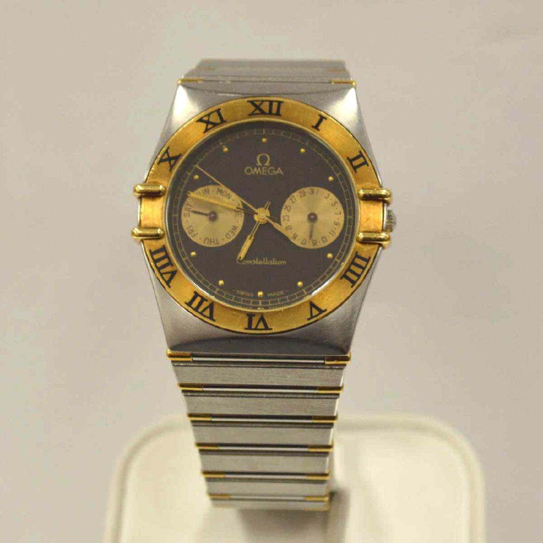 Men's Two Tone Omega Constellation Watch: Men's 18kt and stainless sell Omega Constellation watch featuring a black dial with day and date sub-dials, quartz movement, sapphire crystal, and Roman Numeral bezel and bar style links. Bracelet len