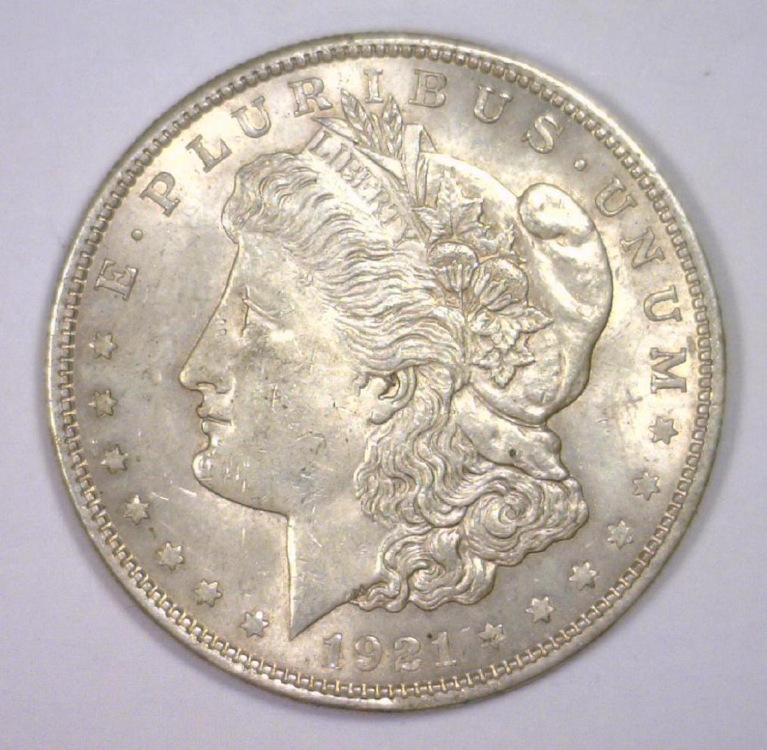 1921 Morgan Silver Dollar About Uncirculated AU: Last year of issue for the iconic Morgan Silver Dollar, this one has seen slight wear, offers some original luster, and is in About Uncirculated condition.