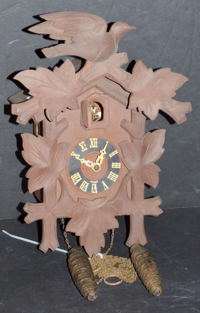 Vintage Cuckoo Clock with Weights & Pendulum: Vintage Black Forrest Type Cuckoo Clock. This is a parts clock & needs pieces. Clock does not work. It does have the bird intact. and pendulum and weights. Marked Germany front and back