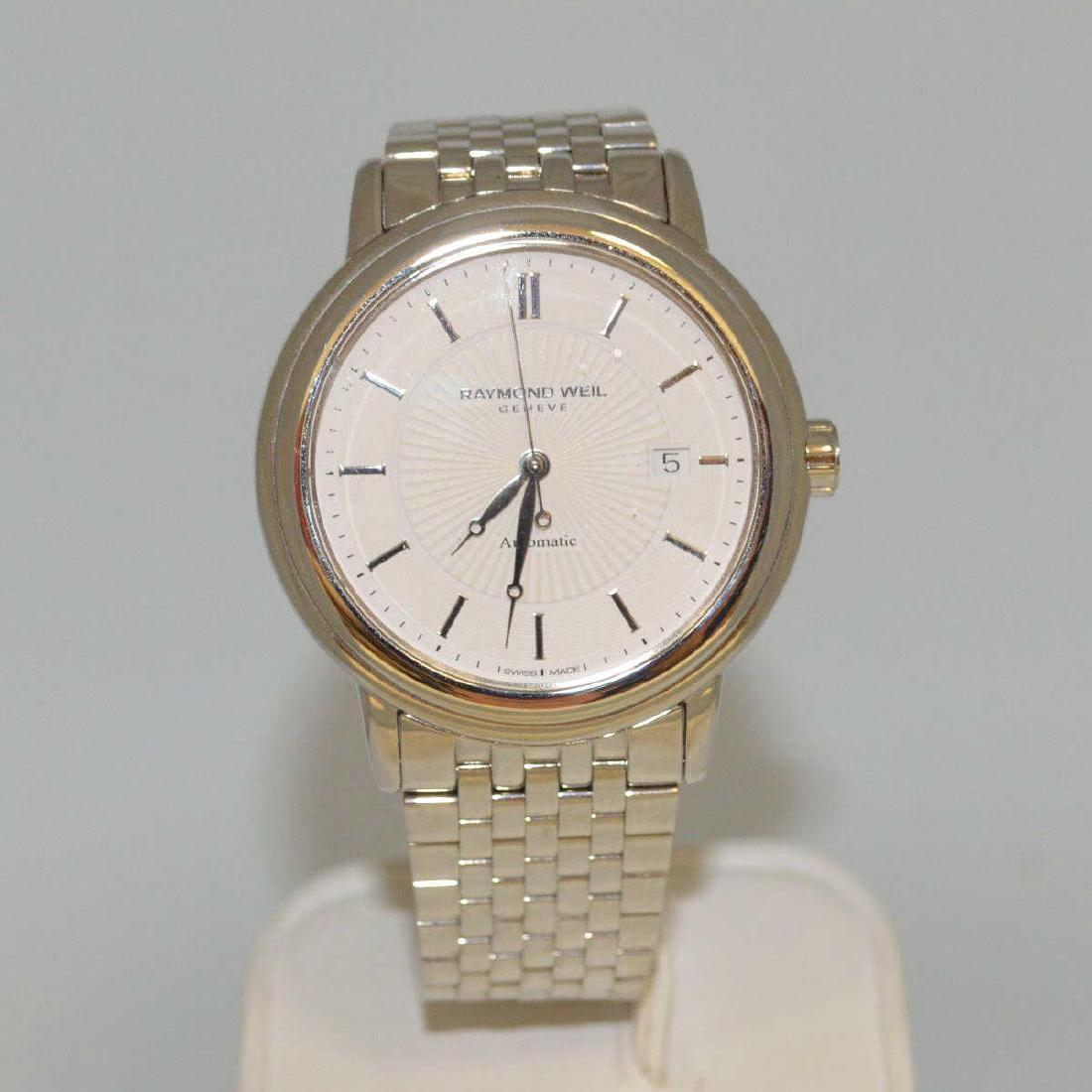 Men's Stainless Automatic Raymond Weil Watch: Men's Stainless Steel Automatic Maestro watch featuring an automatic swiss movement, sapphire crystal, open display back, and white dial with stick marker. Comes with the original box and manual.