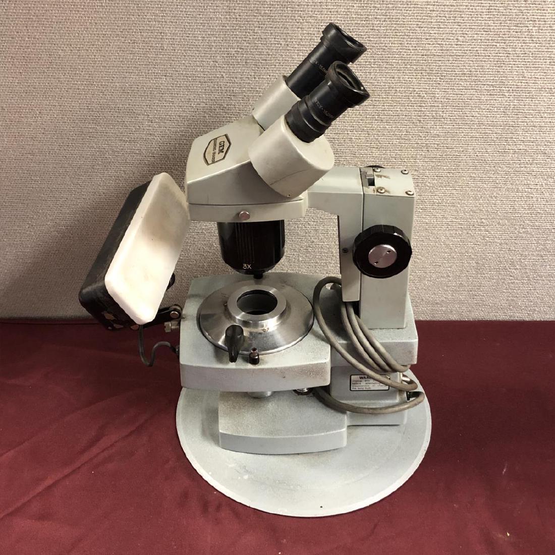 GEM Diamond Grader Model 264 Microscope: GEM Diamond Grader Model No. 264 Electric Lighted Microscope. GIA diamond microscope with a diamond light & dimmer cover. 1X and 3X. Swivels. Dual adjustable eye pieces. It is in good working order. S