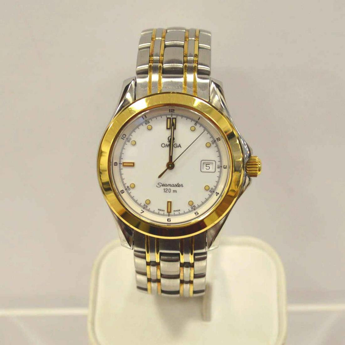 Men's two tone Omega Seamaster quartz watch: Men's two tone Omega Seamaster quartz watch featuring a white dial with dot and stick markers, stainless steel case with an 18kt yellow gold bezel and crown, sapphire crystal, and quartz movement.