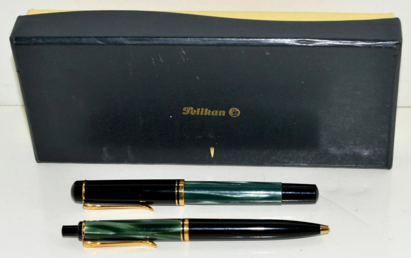 Pelikan 2 Pen Set in Original Box Fountain Cartrdg: Pelikan Two Pen Set in Original Box, Fountain & Cartridge Roller Ball Type. Made in Germany with green & black celluloid barrels with gold toned accoutrements. Obviously used but all in good condition