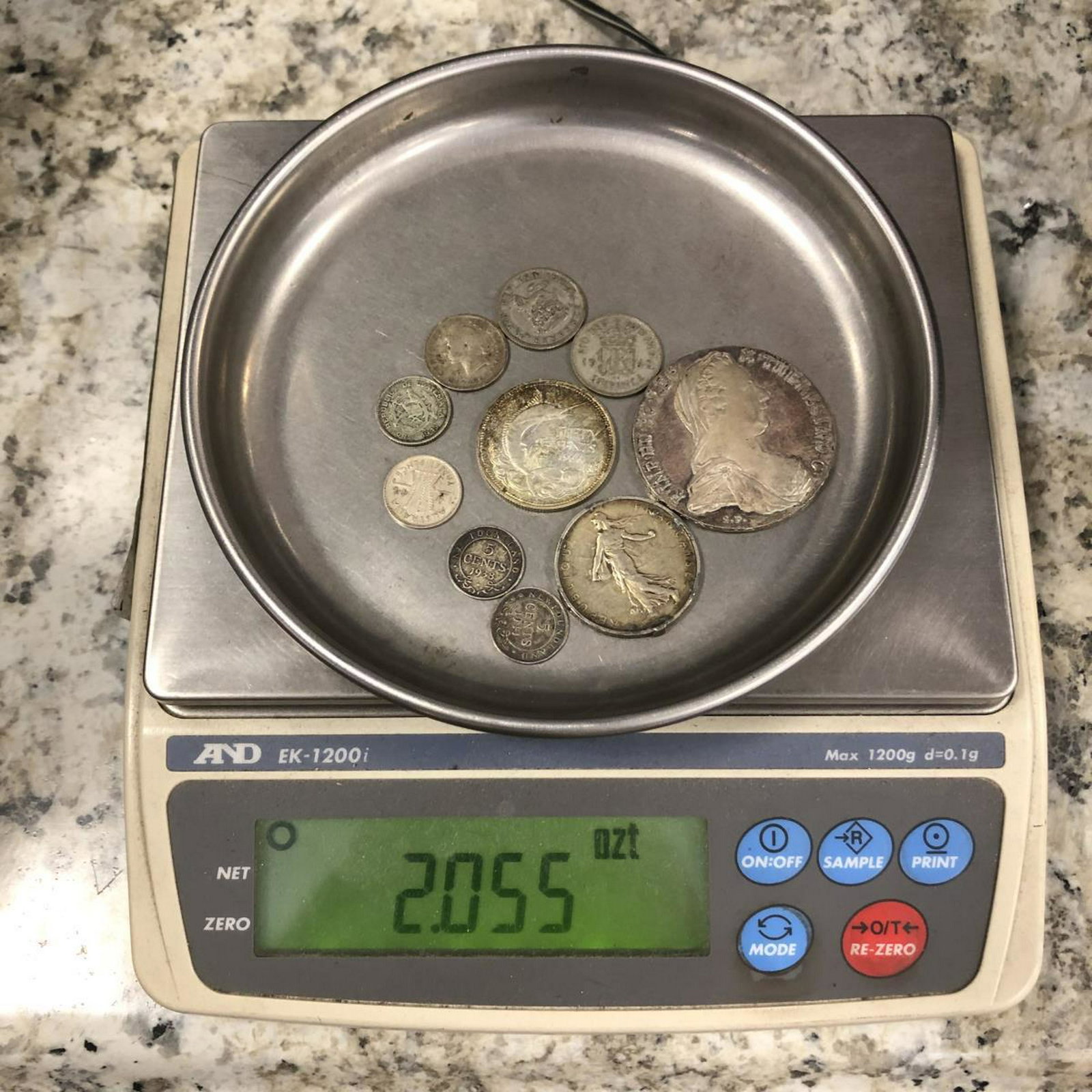 10 Silver World Coins over 2 Ounces: These 10 silver coins are from all over the globe, are made of silver, and has a weight of over 2 troy ounces. In this lot I see a 1780 Maria Theresa Thaler Restrike, a 5 Francs from France, a Marlin 