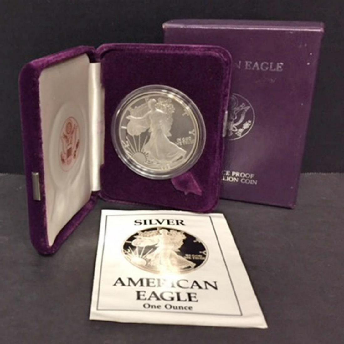 1988 Silver American Proof Eagle with Box & COA: 1988 Silver American Proof Eagle with Box & COA. Third year of issue, this one ounce .999 fine iconic silver coin has deep mirrored fields and frosty cameo devices. Comes with its purple box of issue
