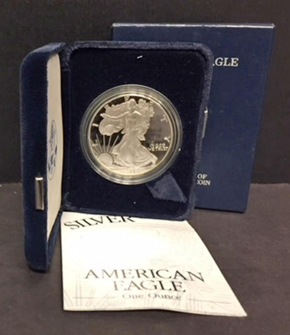 2002 Silver American Proof Eagle with Box & COA: 2002 Silver American Proof Eagle with Box & COA. This one ounce .999 fine iconic silver coin has deep mirrored fields and frosty cameo devices. Comes with its blue box of issue and COA.