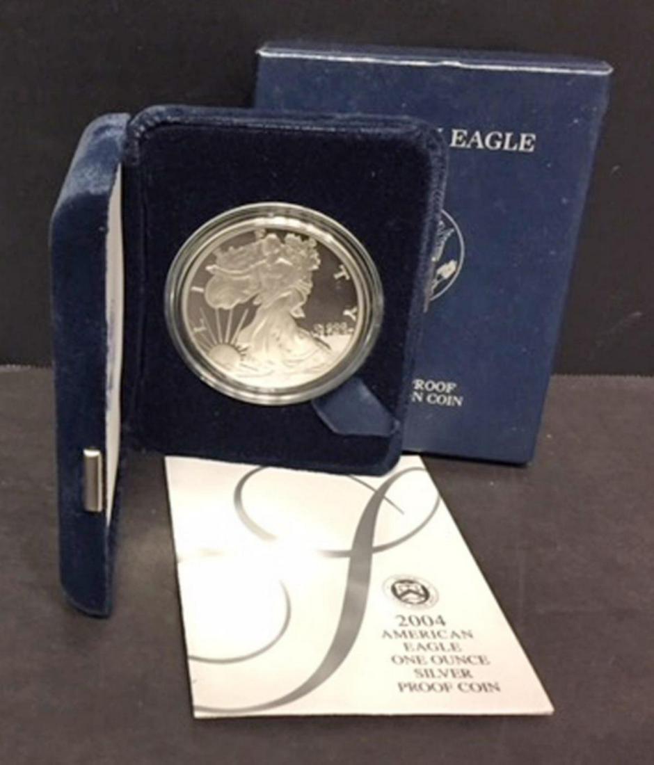 2004 Silver American Proof Eagle with Box & COA: 2004 Silver American Proof Eagle with Box & COA. This one ounce .999 fine iconic silver coin has deep mirrored fields and frosty cameo devices. Comes with its blue box of issue and COA.