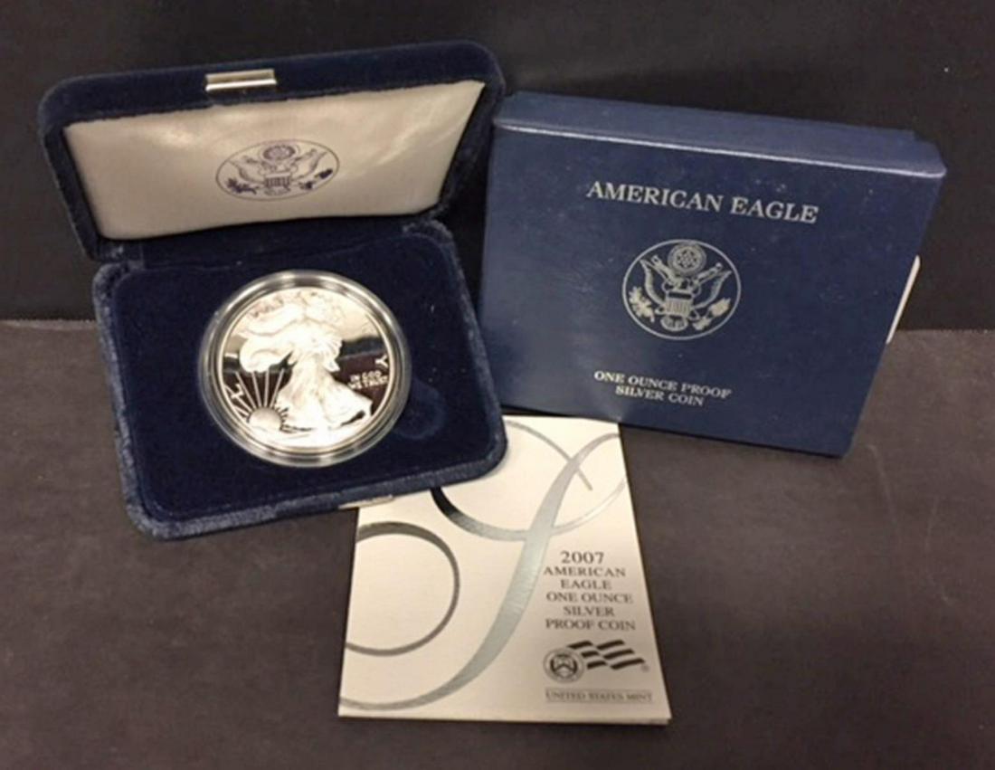 2007 Silver American Proof Eagle with Box & COA: 2007 Silver American Proof Eagle with Box & COA. This one ounce .999 fine iconic silver coin has deep mirrored fields and frosty cameo devices. Comes with its blue box of issue and COA.