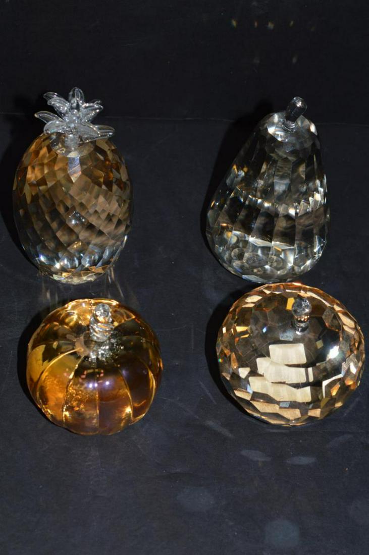 Lot of 4 Glass Crystal Fruit Paperweights: Lot of 4 Glass Crystal Fruit Paperweights from Cassini & Simon Designs. They range in color from light amber to amber colored & are 3" to 5" tall. They are a Oleg Cassini faceted pear, Simon Designs f