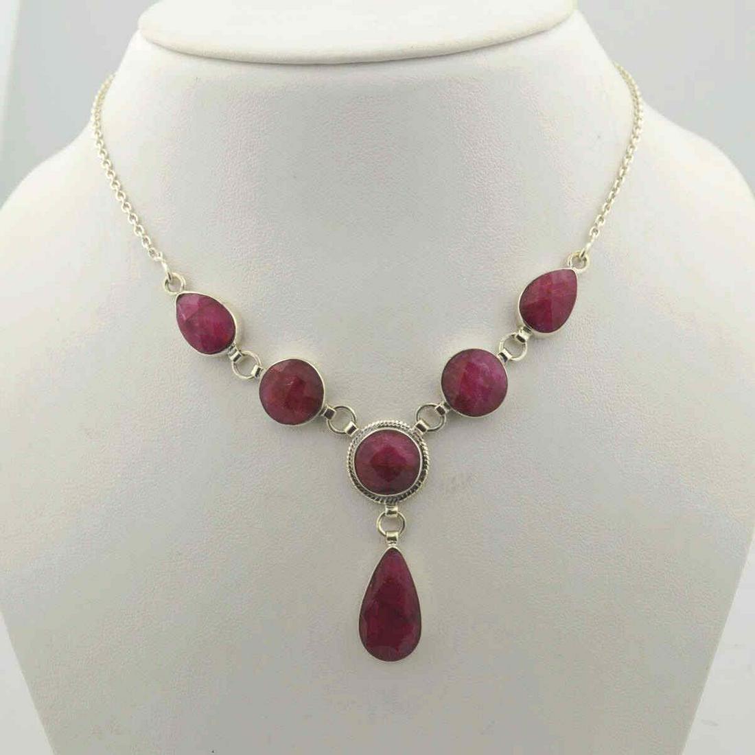 Sterling Silver opaque ruby necklace: Ladies sterling silver opaque ruby necklace featuring various shapes of bezel set opaque rubies weighing approx. 32.00ct. Necklace length 18". Weight 0.50 ozt. TH-530