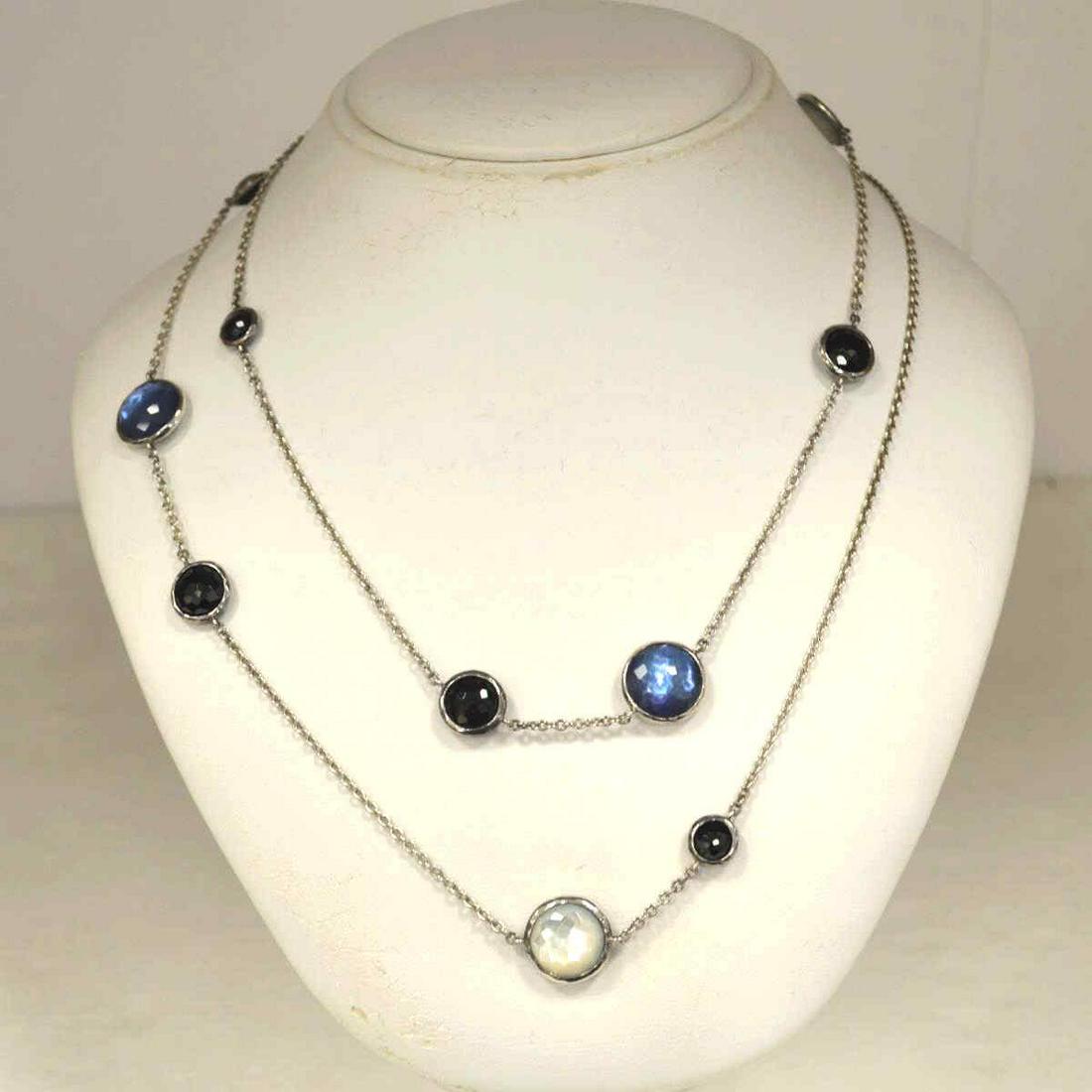 Ippolita sterling mother of pearl station necklace: Ladies sterling silver stations necklace by designer Ippolita from the "Rock Candy collection" featuring faceted bezel set round onyx, mother of pearl and quartz. Length 40". Weight 24.4 grams. Comes 