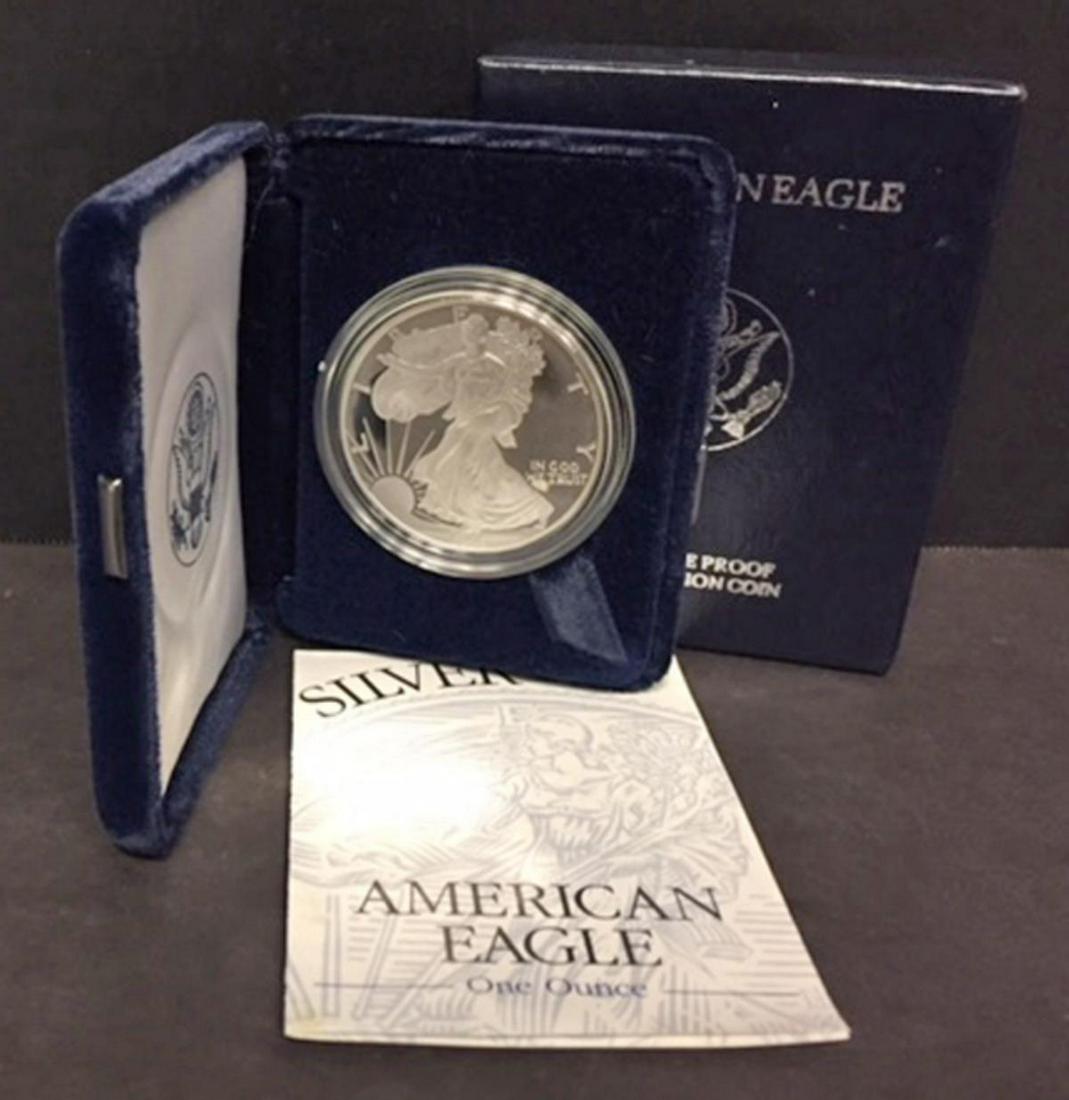 1995 Silver American Proof Eagle with Box & COA: 1995 Silver American Proof Eagle with Box & COA. This one ounce .999 fine iconic silver coin has deep mirrored fields and frosty cameo devices. Comes with its blue box of issue and COA.