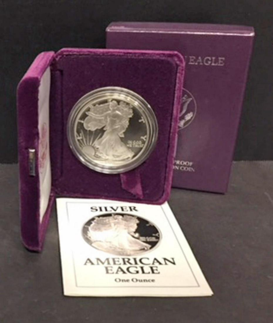 1991 Silver American Proof Eagle with Box & COA: 1991 Silver American Proof Eagle with Box & COA. This one ounce .999 fine iconic silver coin has deep mirrored fields and frosty cameo devices. Comes with its purple box of issue and COA.