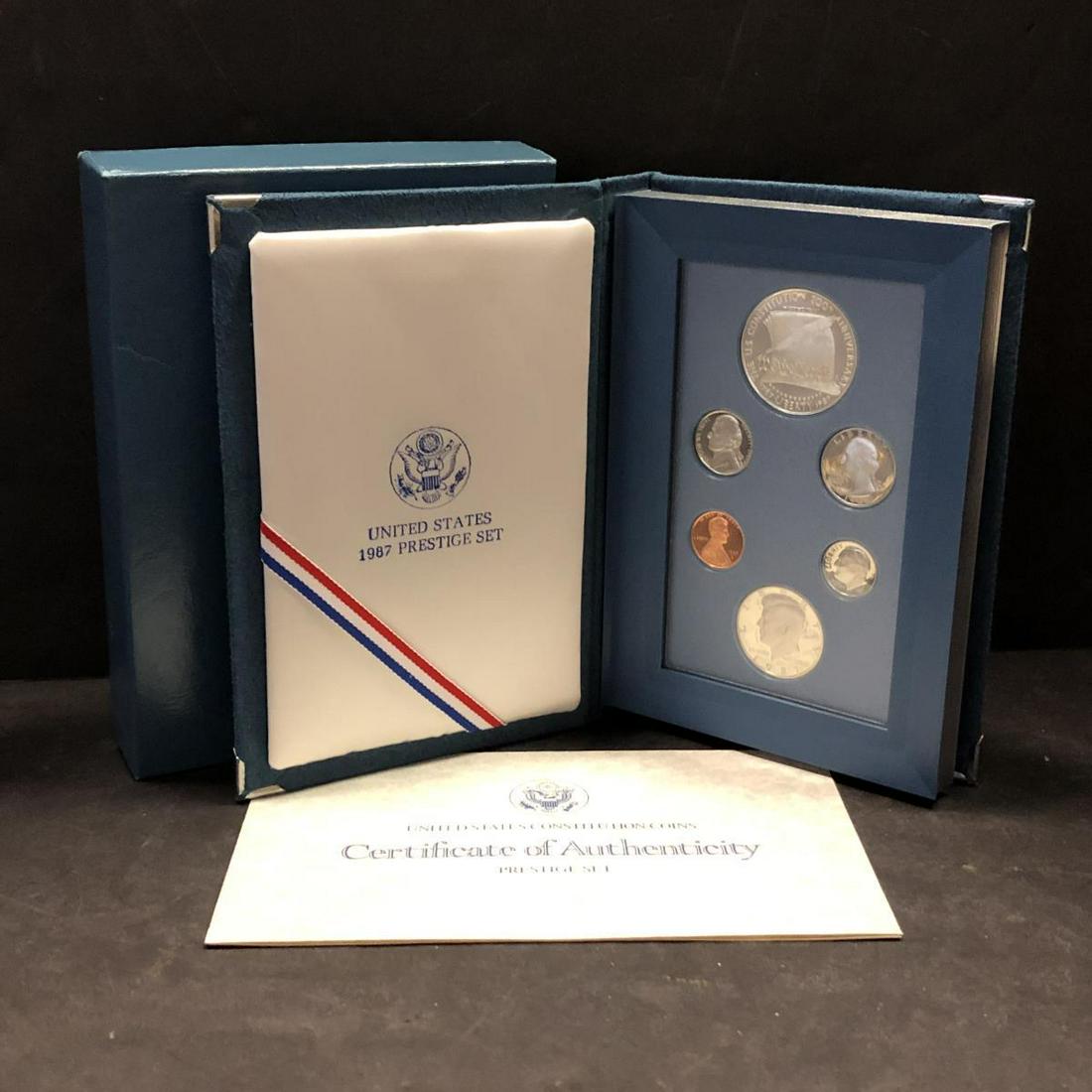 1987 Prestige Proof Set w/Silver Commemorative $1: 1987 Prestige Proof Set w/Silver Commemorative $1. This deluxe proof set features the Lincoln Cent to Kennedy half along with the Constitution silver commemorative dollar. Each coin offers deep mirror