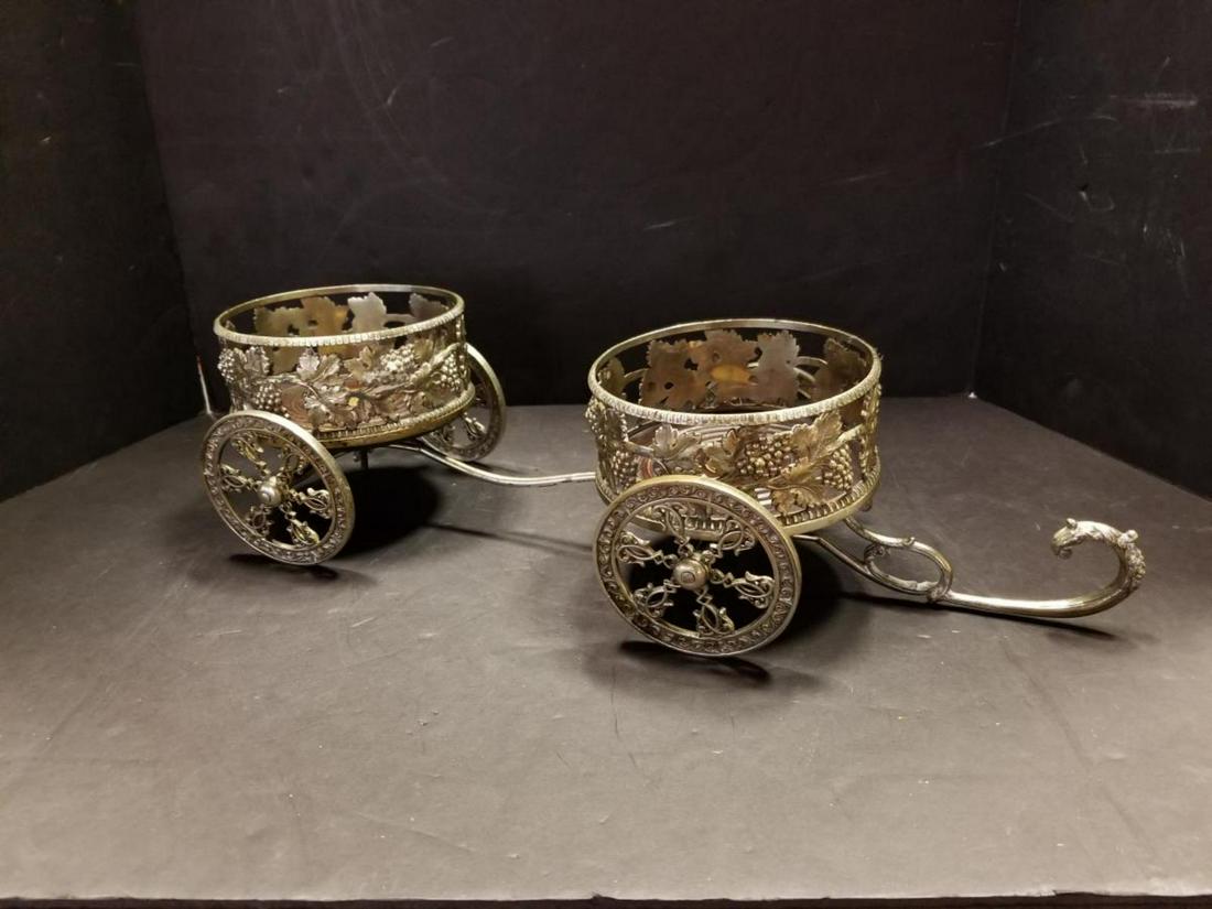 Vintage Silver Plated Wheeled Bottle Caddy: A Vintage Ornate Wheeled Bottle Caddy. Bought in Italy in the 1970's. It is 19 3/4" long & 4 1/2" tall. It holds up to a 5 1/8" bottle on the wood insert. It has a crown hallmark on the swivel pins on