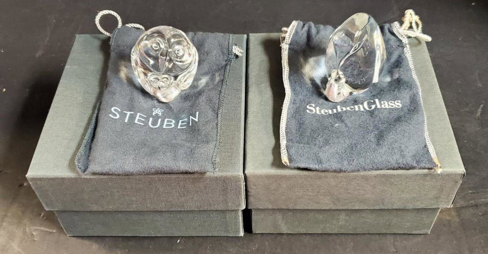 Pair Steuben Crystal Paper Weights Owl & Penguin: Pair of Steuben Crystal Paper Weights or Hand Coolers in Boxes, Owl & Penguin. In original boxes with soft protective clothe pouches. Owl parent & child 2.25" tall, signed on underside. Penguin parent
