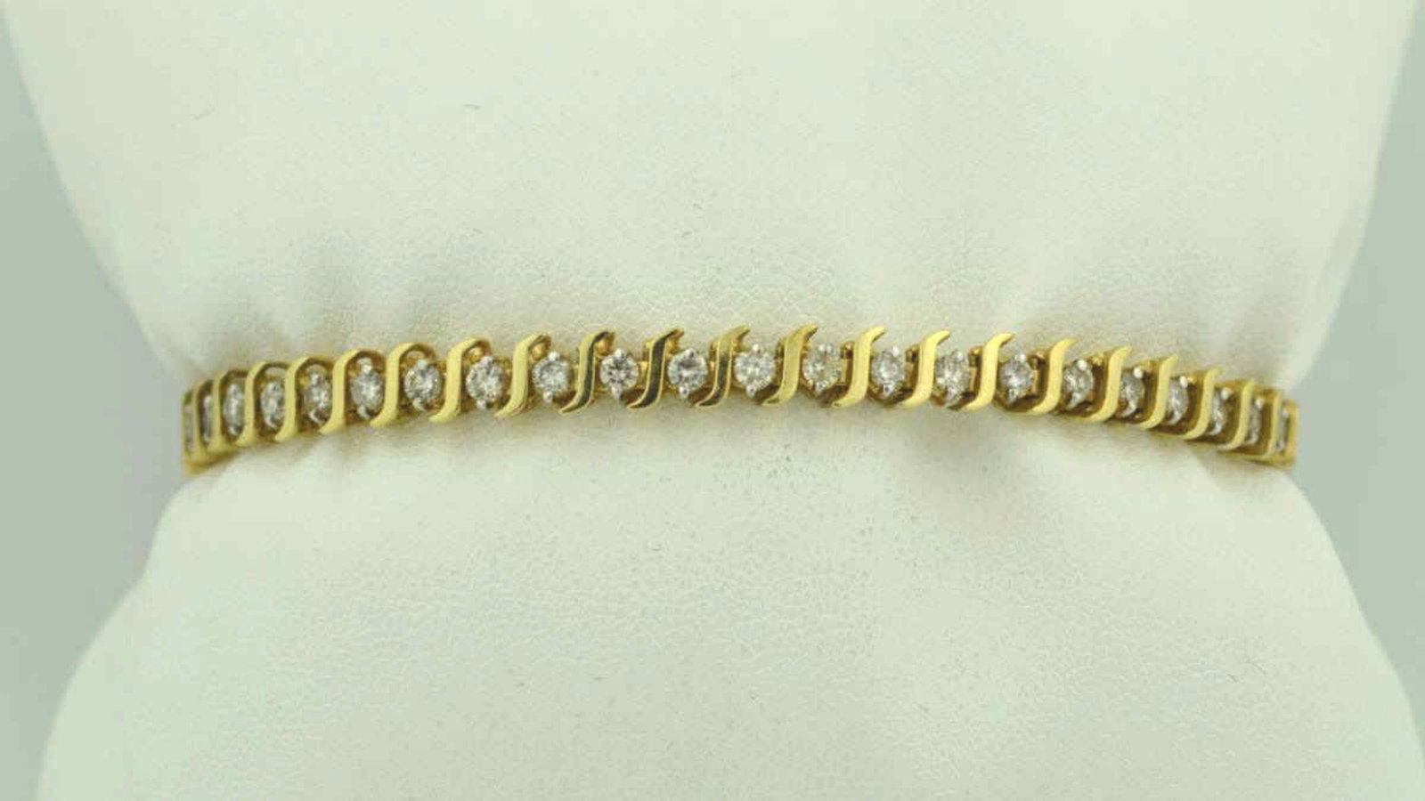 14kt yellow gold diamond tennis bracelet: Ladies 14kt yellow gold diamond tennis bracelet featuring prong set round brilliant cut diamond weighing approx. 2.45ct. Clarity I1-I2, Color H-I. Mounted in an "S" link design. Length 7 1/4". Weight 