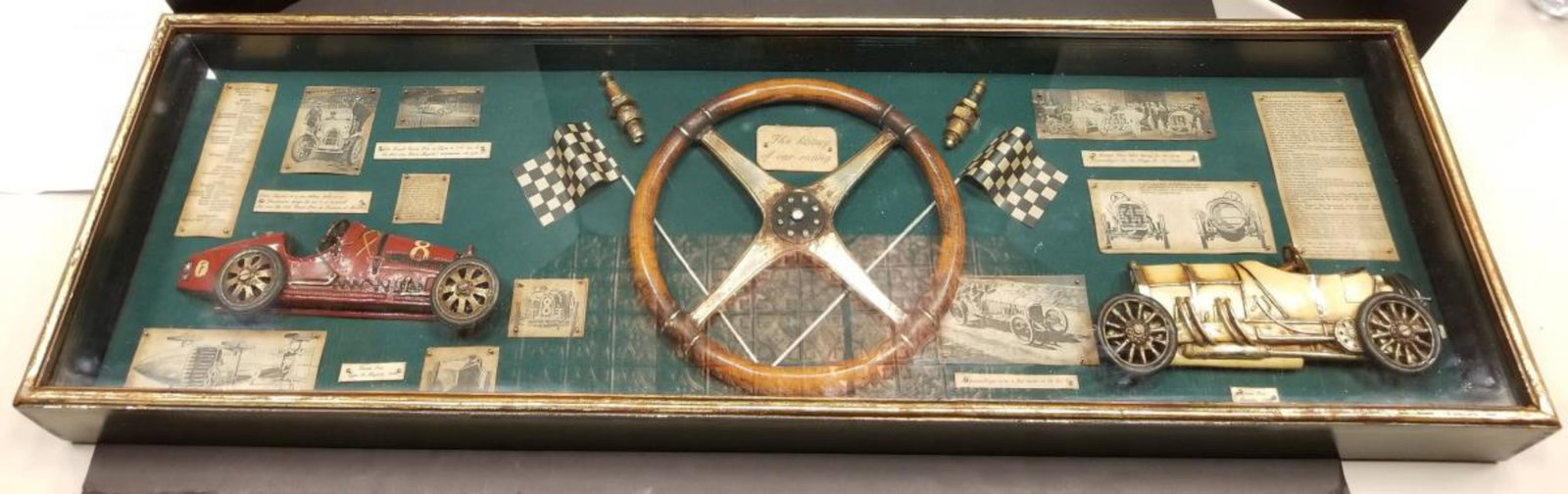 "The History of Car Racing" Shadowbox Decorator: "The History of Car Racing" Shadowbox Decorator Wall hanging. This glass covered, wood framed, vintage styled shadowbox is in great condition & is loaded with replica historic items & illustrations. I
