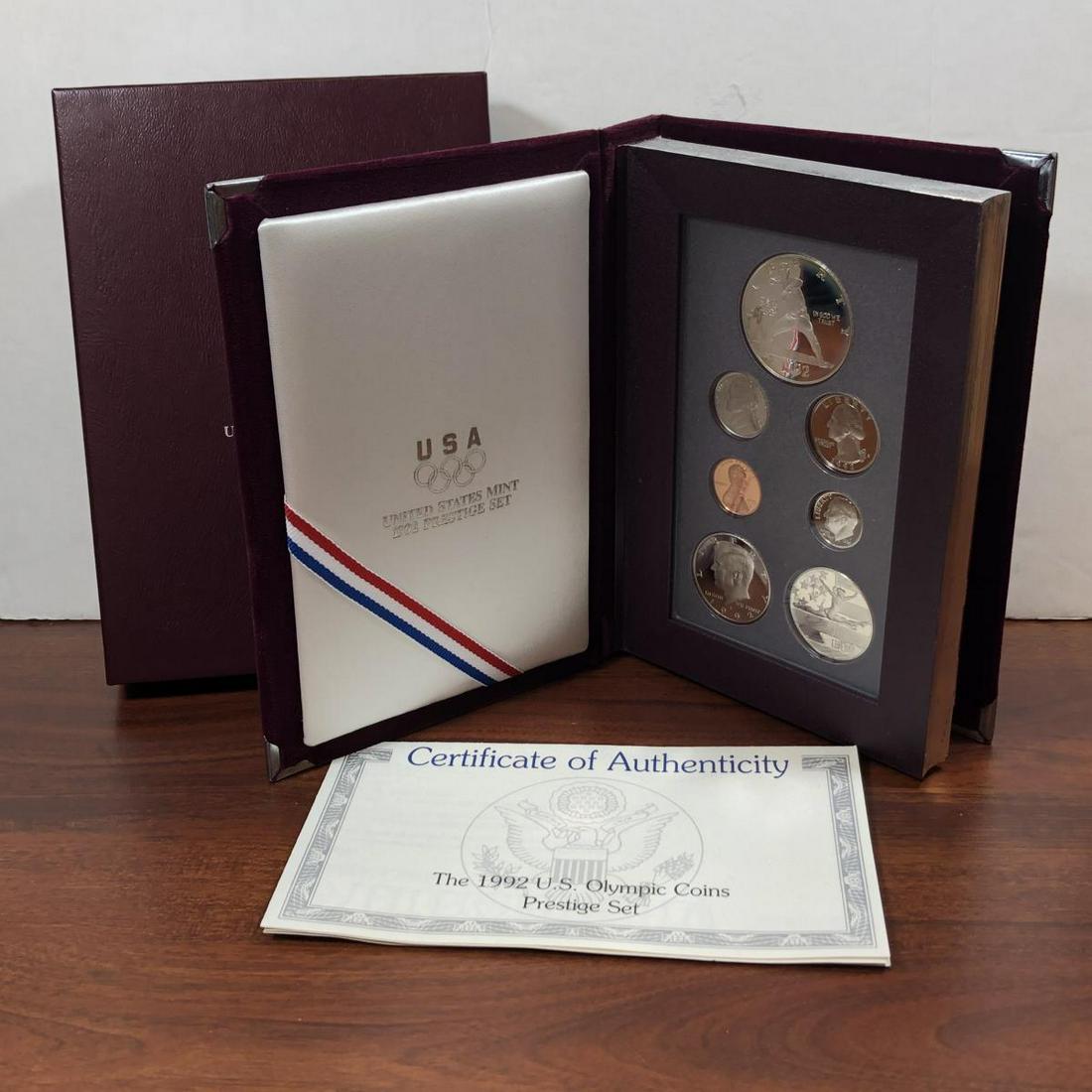 1992 Prestige Proof Set w/ Silver Olympics $1: 1992 Prestige Proof Set w/ Silver Mt. Rushmore $1. This deluxe proof set contains the Lincoln Cent to Kennedy Half, along with the silver Olympics Baseball Commemorative Dollar and Gymnastics clad hal