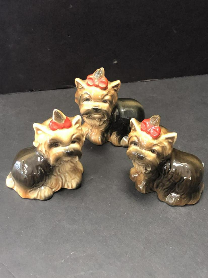 Group of 3 Goebel Collectible Yorkie Figurines: Group of 3 Goebel Collectible Yorkie Figurines. These fun tan & brown or tan & black Yorkshire Terriers have a red bow on top of their heads & are in great condition. They are marked on the underside