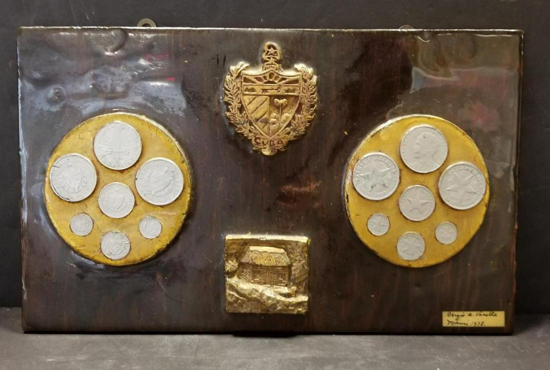 Cuban Coins & Cuba Coat of Arms on Wood Plaque: 14 Cuban Coins, Cuba Coat of Arms and Log Cabin Symbol Mounted on a Varnished Wood Plaque. There also is a Signed Name that Appears to Read Sergis Vanalls, Miami 1978.