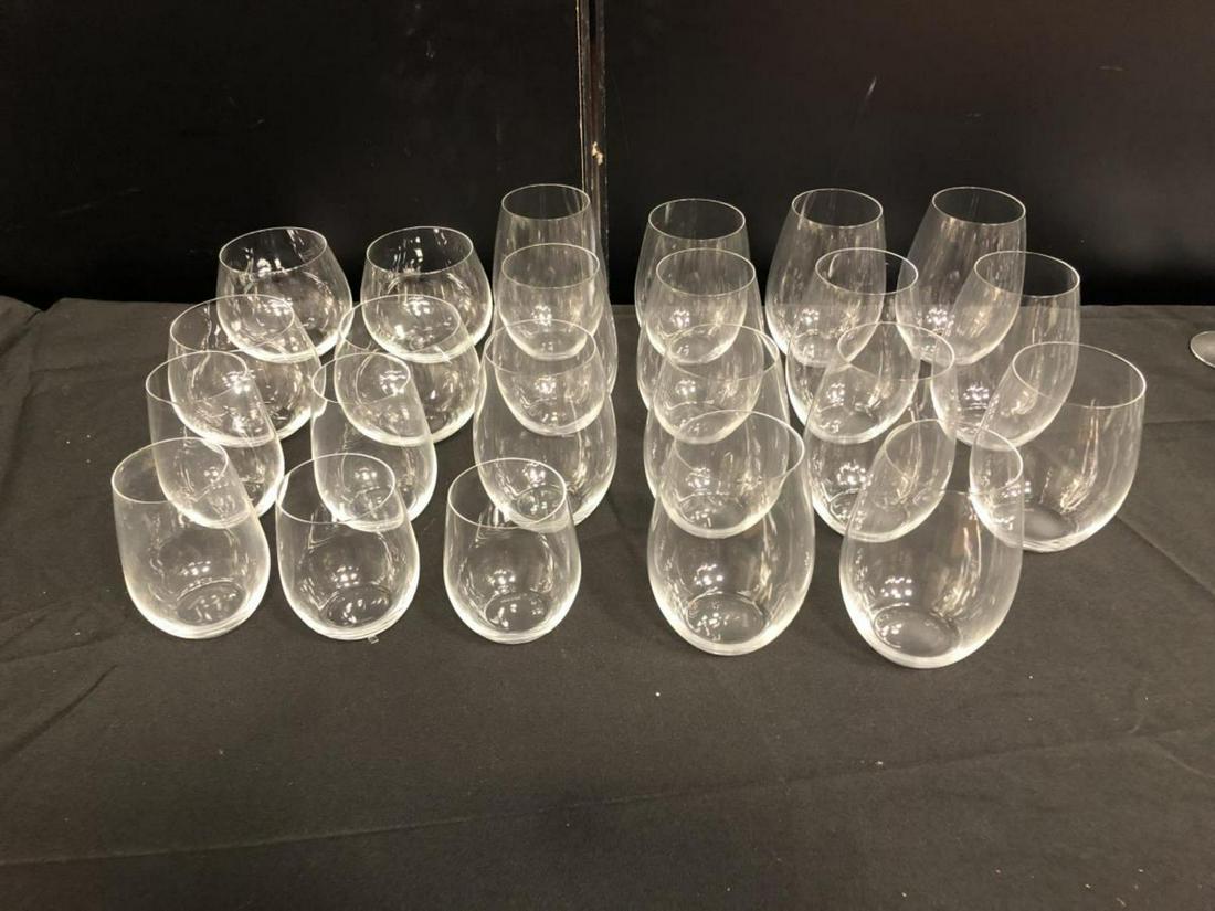 Set Of Riedel Stemless Wine Glasses 23 pcs: Set Of Riedel Stemless Wine Glasses. Total of 23 glasses. Consists of 4 glasses standing 4" tall. 2 glasses standing 5" tall. 3 glasses standing 4 3/4" tall. 12 glasses standing 5 1/2" tall. 2 glasses