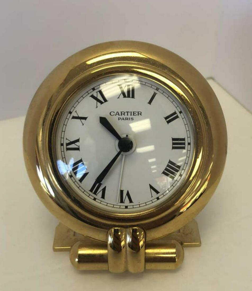 Cartier Brass Lacquered Travel Alarm Folding Clock: Cartier Brass Travel Desk Alarm Clock, Quartz Movement. Cartier Paris engraved on reverse. Made in France. Measures 3-3/4" H, 3" W. Good condition. Some surface wear. Needs a battery. 2-inch white cir