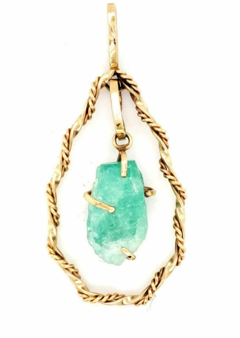 14kt yellow gold Atosha emerald pendant: Ladies 14kt yellow gold Atosha emerald pendant featuring a prong set rough, light green emerald recovered from the shipwrecked Spanish Galleon, Nuestra de Atocha weighing approx. 14.49ct. Mounted in a